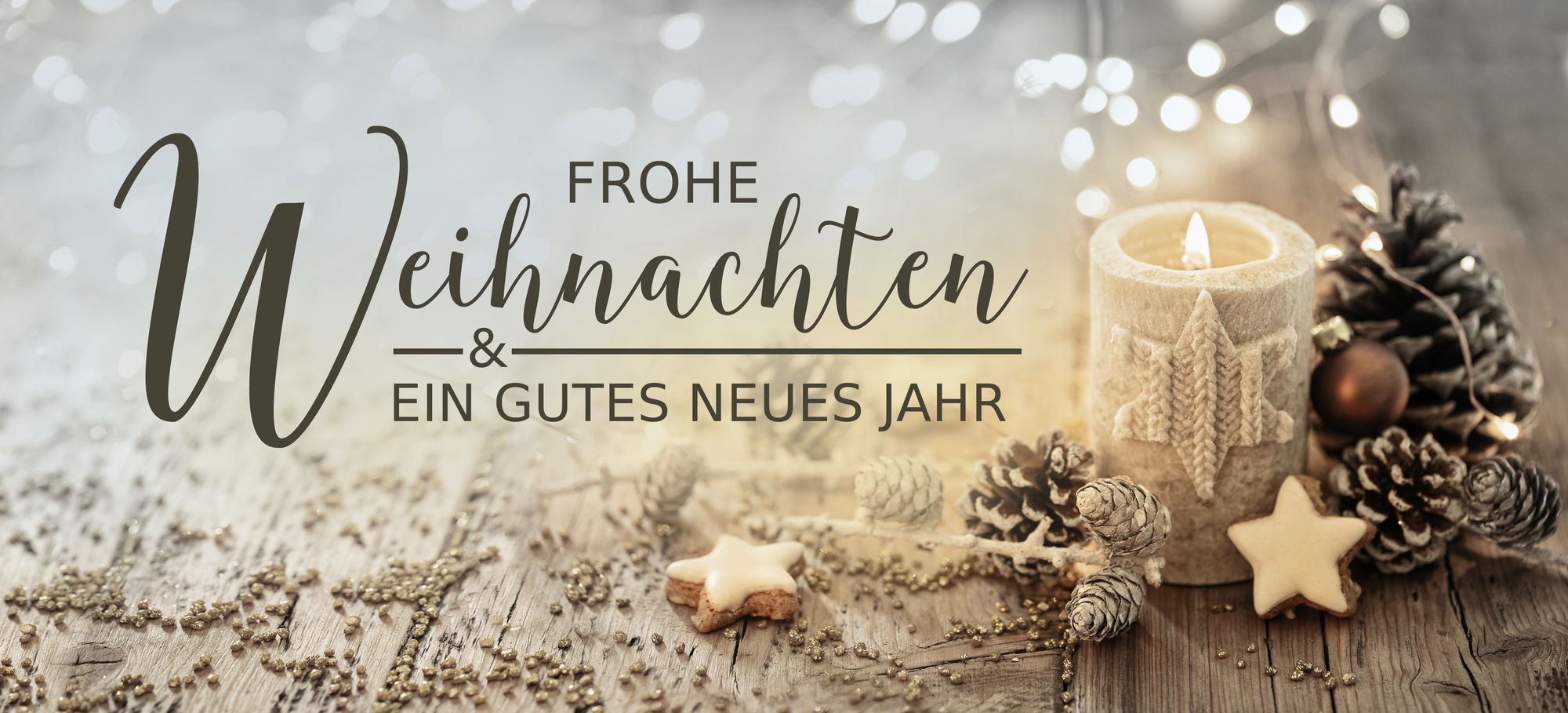 Christmas greeting card german text - Merry Christmas and happy new year - White burning candle with natural decoration on rustic light wood