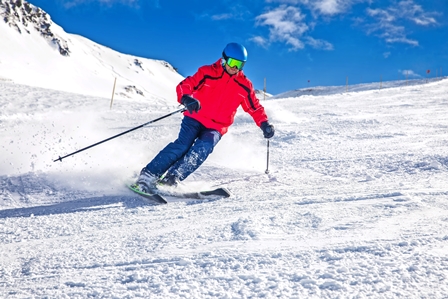 Man skiing on the prepared slope with fresh new powder snow in Tyrolian Alps, Zillertal, Austria