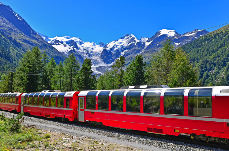 Swiss mountain train Bernina Express crossed Alps with glaciers in the backgroundin the summer