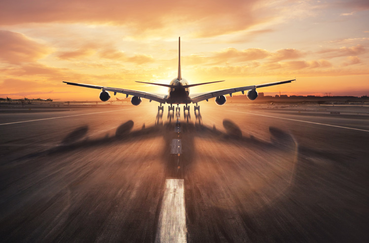 Huge two storeys commercial jetliner taking off runway. Modern and fastest mode of transportation. Dramatic sunset sky on background