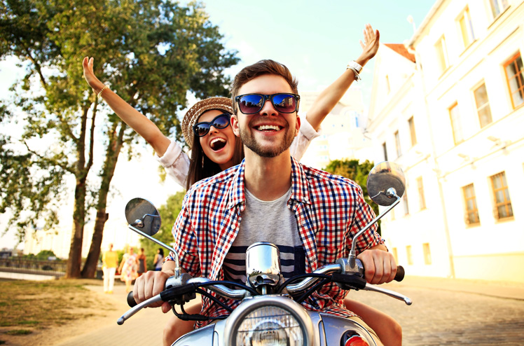 Couple in love riding a motorbike , Handsome guy and young sexy woman travel . Young riders  enjoying themselves on trip. Adventure and vacations concept.