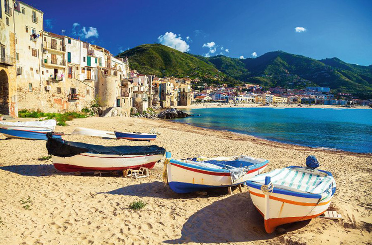 old wooden fishing boats on the beach of Cefalu