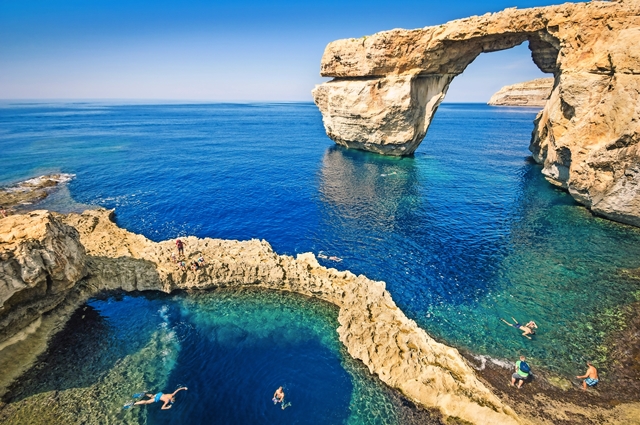 The world famous Azure Window in Gozo island - Mediterranean nature wonder in the beautiful Malta - Unrecognizable touristic scuba divers
