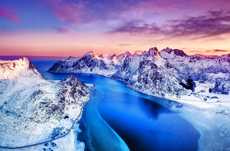 Aerial view at the Lofoten islands, Norway. Mountains and sea during sunset. Natural landscape from air at the drone. Norway at the winter time