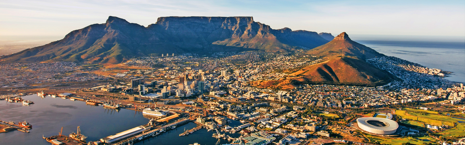 Aerial coastal view of cape town city with table mountain, cape town harbour, lions head and devils peak, South africa.