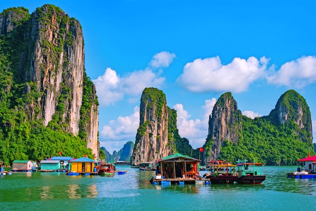 Floating fishing village and rock island in Halong Bay, Vietnam, Southeast Asia. UNESCO World Heritage Site. Junk boat cruise to Ha Long Bay. Landscape. Popular landmark, famous destination of Vietnam